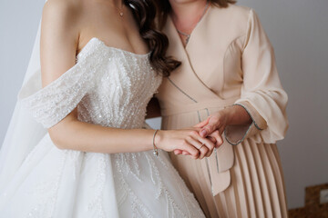 Mother and daughter share a touching moment before wedding ceremony in elegant setting