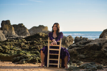Young woman, beautiful, brunette, flamenco dancer, barefoot, wearing a beautiful velvet dress,...