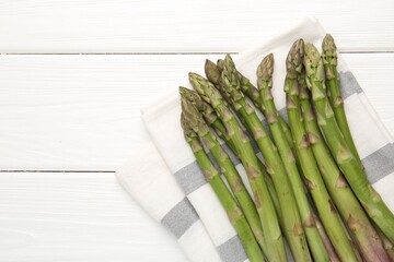 Fresh raw asparagus spears on white wooden table, top view. Space for text