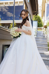 Elegant bride preparing for her wedding on a bright and sunny day in a modern venue