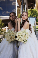 Bride posing elegantly with bouquet of white roses in serene outdoor setting