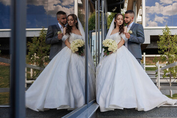 Couple shares a romantic moment outside during their wedding day celebration