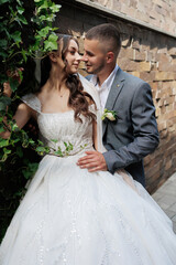 Couple celebrates their wedding day in a beautiful outdoor setting with lush greenery