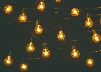 Background - electric garland with incandescent bulbs, yellow warm light