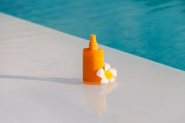Sunscreen by the pool. Summer travel, vacation, holiday and weekend concept.