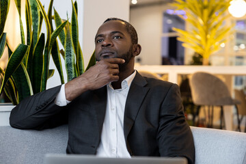 African american businessman working on a laptop and looking serious