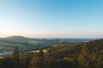 Sunset over forest and valley in Jeseniky mountains, Czech Republic. Harmony between nature and people.