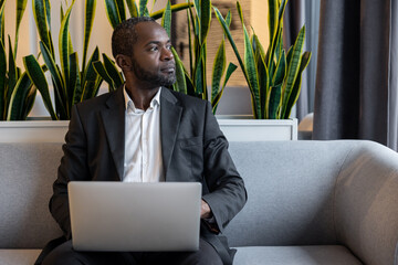 Businessman working on a laptop and looking busy and thoughtful