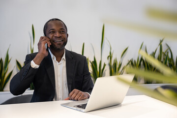 Businessman having a phone call and smiling positively