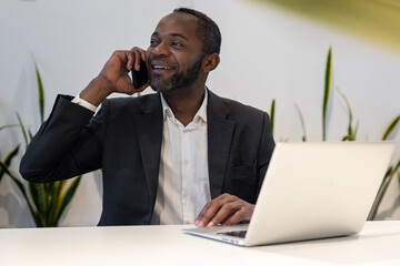 Businessman having a phone call and smiling positively