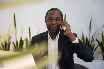 Businessman having a phone call and smiling positively