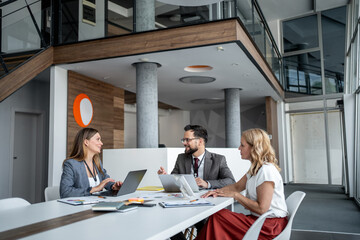 Business people working together on project in modern office meeting room