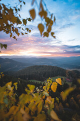 Beskydy mountains at colorful sunset. Autumn forest, rolling hills and peaceful valley evoke...