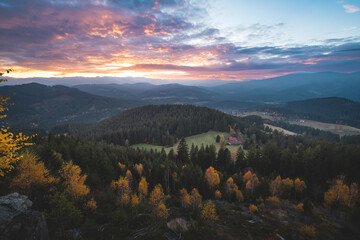 Beskydy mountains at colorful sunset. Autumn forest, rolling hills and peaceful valley evoke...