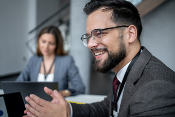 Businessman gesturing while talking with colleagues in meeting room