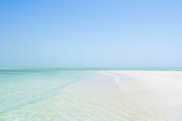 Fototapeta premium Serene tropical beach paradise with turquoise water and white sand in sunny day