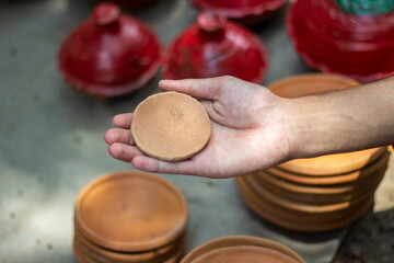 A handsome boy is holding a terracotta product