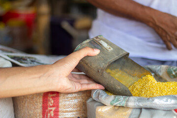 A man holds some Lentils in a sack