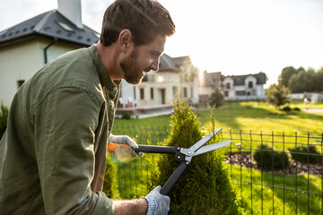 Man in the garden working with the prune and looking involved