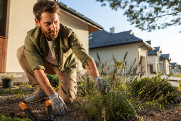 Man working in the garden and looking involved and busy