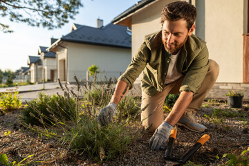 Man working in the garden and looking involved and busy