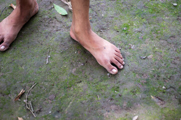 A boy is standing with two feet on the ground