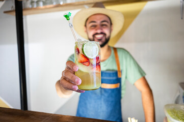 Bartender offering refreshing fruit cocktail at the bar counter