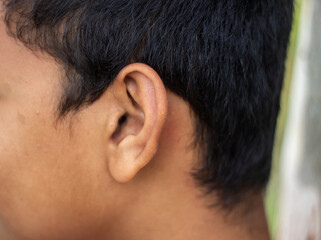 A part of a human ear and some hair