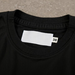 black shirt with white label with concrete background