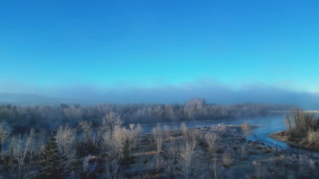 xa drone aerial view over sunrise on a foggy morning is highly atmospheric and cinematic, perfect for stock platforms, Drone Aerial View of Sunrise Over Foggy Landscape &ndash; Peaceful Morning Atmosphere