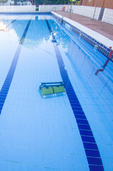 Robot cleaning and vacuuming the bottom of the pool