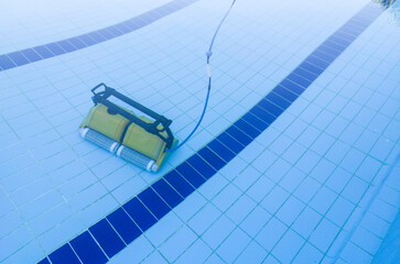 Robot cleaning and vacuuming the bottom of the pool