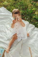 Happy little baby girl playing in a sunny park. Childhood joy, Mother's Day, outdoor activity,...