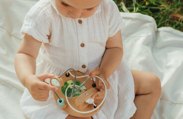 Happy little baby girl playing in a sunny park. Childhood joy, Mother's Day, outdoor activity,...