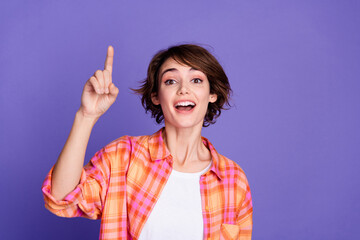 Portrait of pretty young lady point finger wear shirt isolated on purple color background