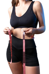 A young slim fit girl with a measuring tape at her waist poses in the studio.