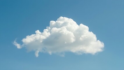 Fluffy cumulus cloud isolated against clear blue sky with soft aerial perspective and natural daylight.