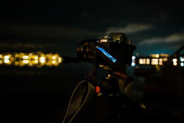 Close-up of a digital camera on a tripod at night