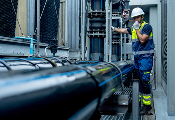 Engineer or technician worker use walkie talkie to contact co-worker  during work with temperature...