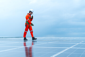 Technician or factory worker use walkie talkie to contact co-worker and also walk along the way to ...