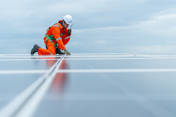 Technician worker or professional engineer sit on solar cell panel and use walkie-talkie during...