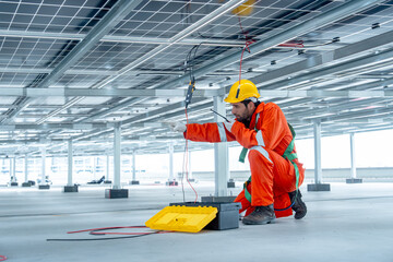 Professional technician worker or engineer use walkie talkie to contact his co-worker and point to...