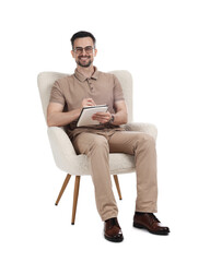 Professional psychologist with notebook in armchair on white background