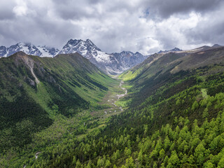 Fototapeta premium Beautiful aerial view of U-shaped valley landscape in Baima Snow Mountain