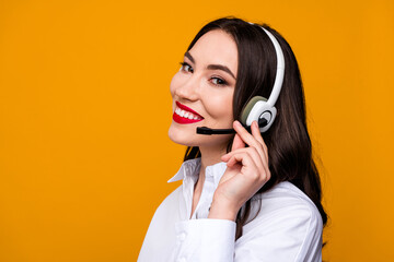 Young businesswoman in stylish formal attire with a headset, advertising or working, vibrant yellow...