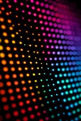 Abstract background of an LED screen with a rainbow spectrum of dots and perspective.