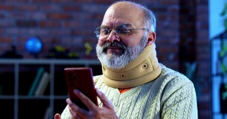 Indian senior man using smartphone with tea at home at table, relaxed elderly person browsing mobile phone while enjoying hot beverage in peaceful morning routine in cozy Indian indoor setting - Powered by Adobe