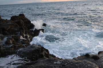 Sea waves in Japan crashing against stones