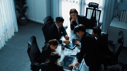 Top view businesspeople placed tablet at table and planning strategy while diverse team discuss...