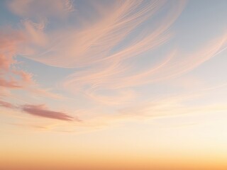 Delicate strands of peach and pink clouds painted across a soft blue canvas during the quiet moments of the morning light.